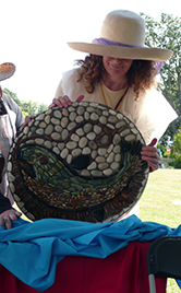 BCI Outreach volunteer with stone mosaics made at Bowker Creek celebration events