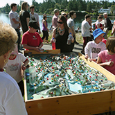 Kids enjoying the watershed model at Canada Day celebrations