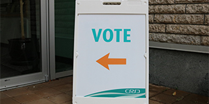 'vote' sign pointing toward door