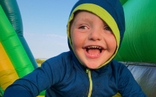 A child smiles at the camera while participating in Play in the Park events with Panorama Recreation.